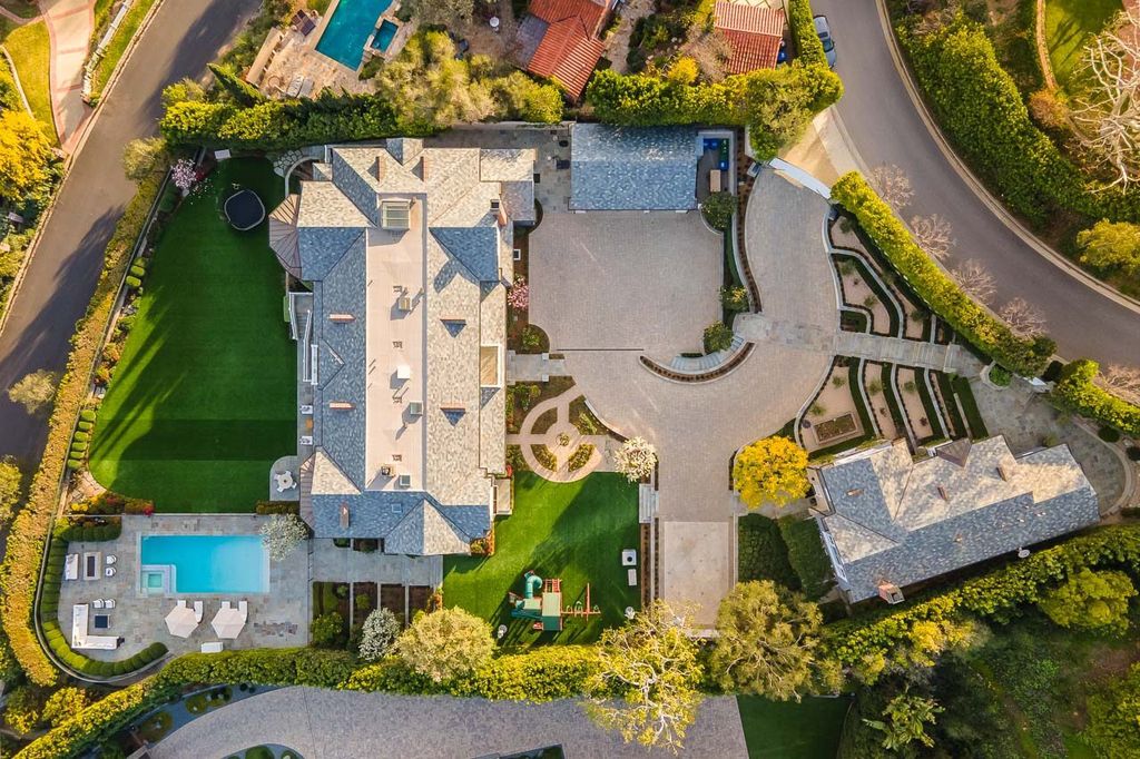 This stunning estate located at 1678 Alta Mura Rd in Pacific Palisades, California 90272, is a true gem of the Palisades Riviera. Boasting 8 bedrooms, 14 bathrooms, and a living space of 16,000 square feet on a 1.08-acre lot, this LEED-certified compound offers luxury and privacy in an unbeatable location.