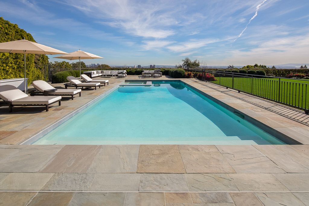 This stunning estate located at 1678 Alta Mura Rd in Pacific Palisades, California 90272, is a true gem of the Palisades Riviera. Boasting 8 bedrooms, 14 bathrooms, and a living space of 16,000 square feet on a 1.08-acre lot, this LEED-certified compound offers luxury and privacy in an unbeatable location.