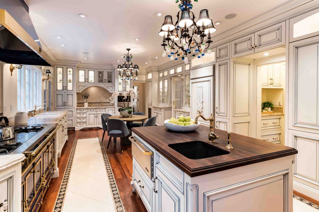 18 Cowell Lane Home in Atherton, California. Indulge in the perfect blend of privacy and luxury within the serene surroundings of this magnificent Atherton estate. Nestled on over an acre of meticulously maintained grounds, this exceptional home exudes style and elegance at every turn, boasting over 6,800 square feet of living space. Impeccable craftsmanship is showcased throughout, with exquisite details including stone, marble, and mahogany finishes. 