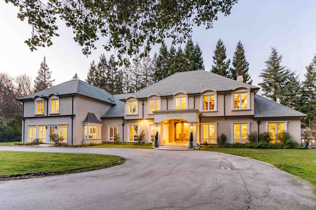 18 Cowell Lane Home in Atherton, California. Indulge in the perfect blend of privacy and luxury within the serene surroundings of this magnificent Atherton estate. Nestled on over an acre of meticulously maintained grounds, this exceptional home exudes style and elegance at every turn, boasting over 6,800 square feet of living space. Impeccable craftsmanship is showcased throughout, with exquisite details including stone, marble, and mahogany finishes. 
