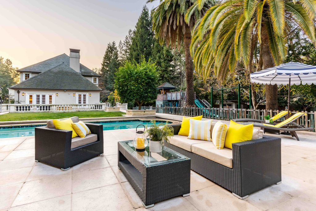 18 Cowell Lane Home in Atherton, California. Indulge in the perfect blend of privacy and luxury within the serene surroundings of this magnificent Atherton estate. Nestled on over an acre of meticulously maintained grounds, this exceptional home exudes style and elegance at every turn, boasting over 6,800 square feet of living space. Impeccable craftsmanship is showcased throughout, with exquisite details including stone, marble, and mahogany finishes. 