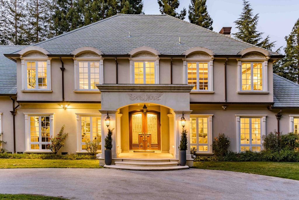 18 Cowell Lane Home in Atherton, California. Indulge in the perfect blend of privacy and luxury within the serene surroundings of this magnificent Atherton estate. Nestled on over an acre of meticulously maintained grounds, this exceptional home exudes style and elegance at every turn, boasting over 6,800 square feet of living space. Impeccable craftsmanship is showcased throughout, with exquisite details including stone, marble, and mahogany finishes. 