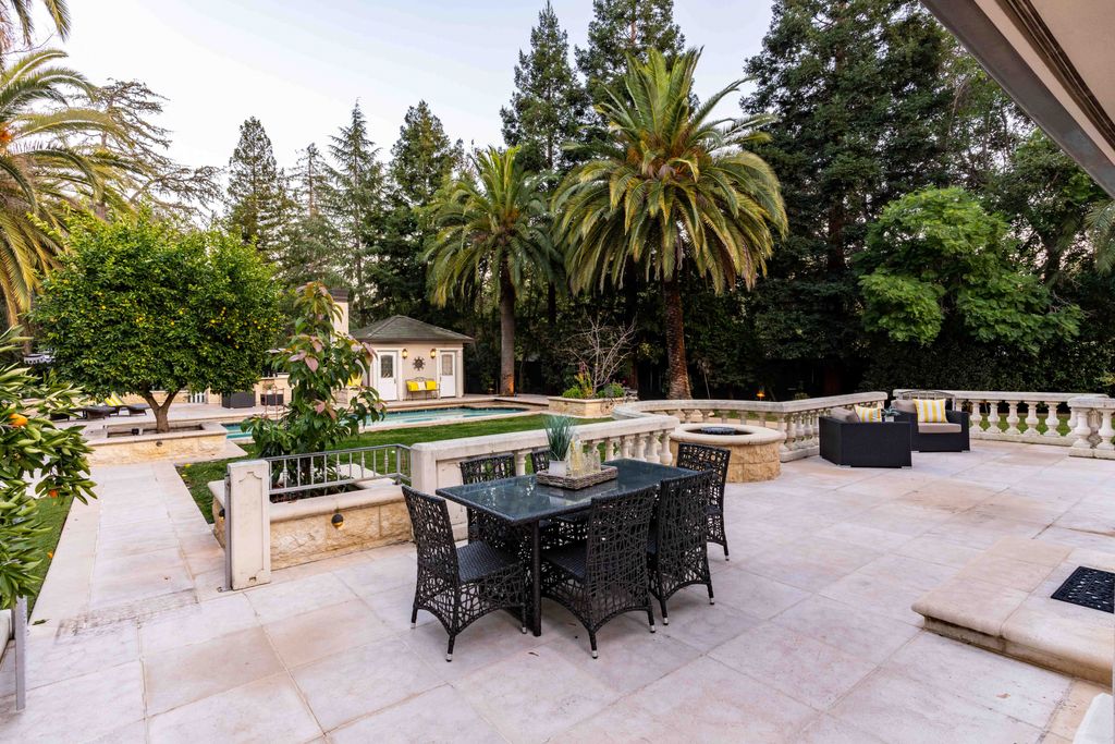 18 Cowell Lane Home in Atherton, California. Indulge in the perfect blend of privacy and luxury within the serene surroundings of this magnificent Atherton estate. Nestled on over an acre of meticulously maintained grounds, this exceptional home exudes style and elegance at every turn, boasting over 6,800 square feet of living space. Impeccable craftsmanship is showcased throughout, with exquisite details including stone, marble, and mahogany finishes. 