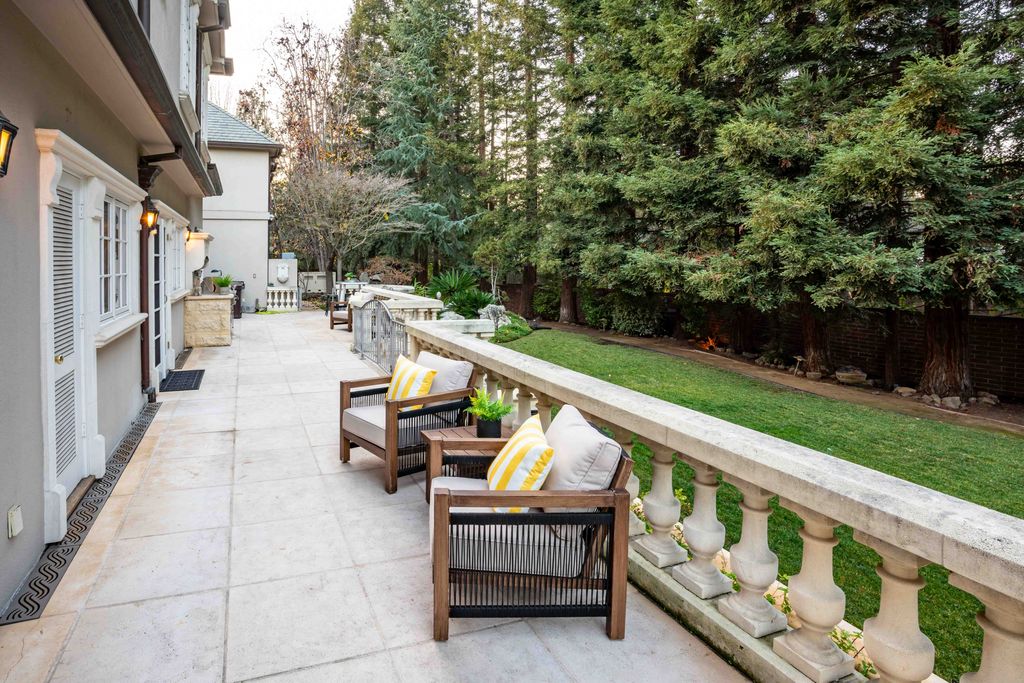 18 Cowell Lane Home in Atherton, California. Indulge in the perfect blend of privacy and luxury within the serene surroundings of this magnificent Atherton estate. Nestled on over an acre of meticulously maintained grounds, this exceptional home exudes style and elegance at every turn, boasting over 6,800 square feet of living space. Impeccable craftsmanship is showcased throughout, with exquisite details including stone, marble, and mahogany finishes. 