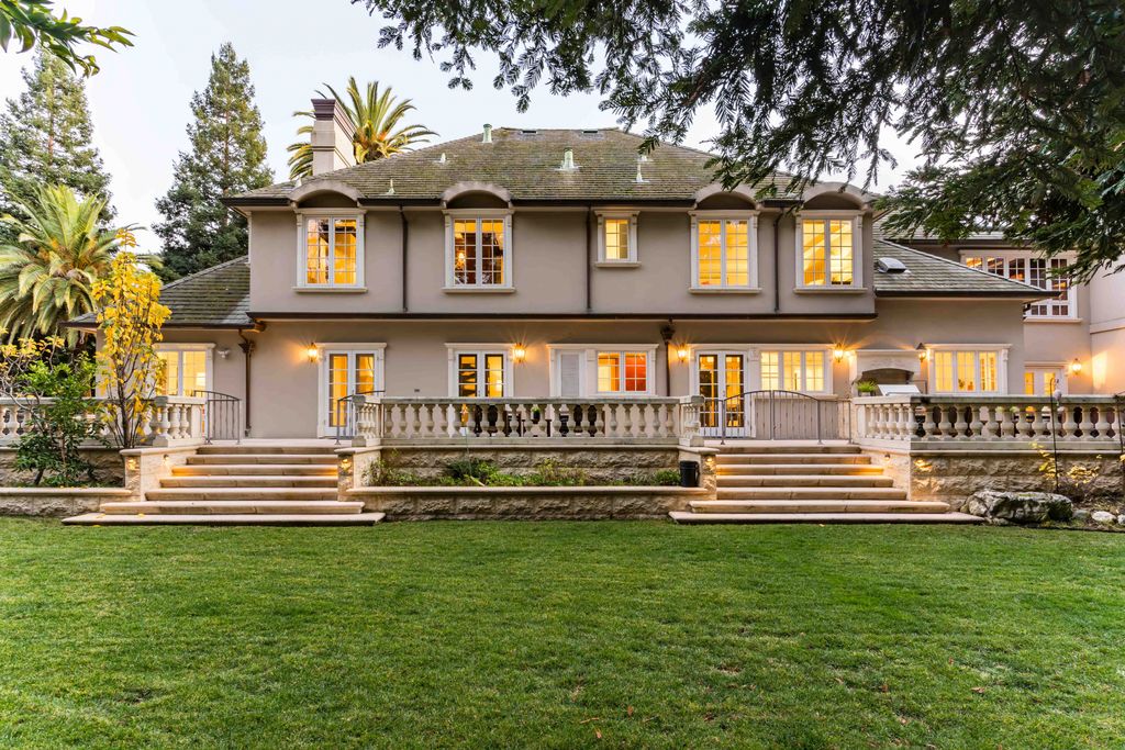 18 Cowell Lane Home in Atherton, California. Indulge in the perfect blend of privacy and luxury within the serene surroundings of this magnificent Atherton estate. Nestled on over an acre of meticulously maintained grounds, this exceptional home exudes style and elegance at every turn, boasting over 6,800 square feet of living space. Impeccable craftsmanship is showcased throughout, with exquisite details including stone, marble, and mahogany finishes. 