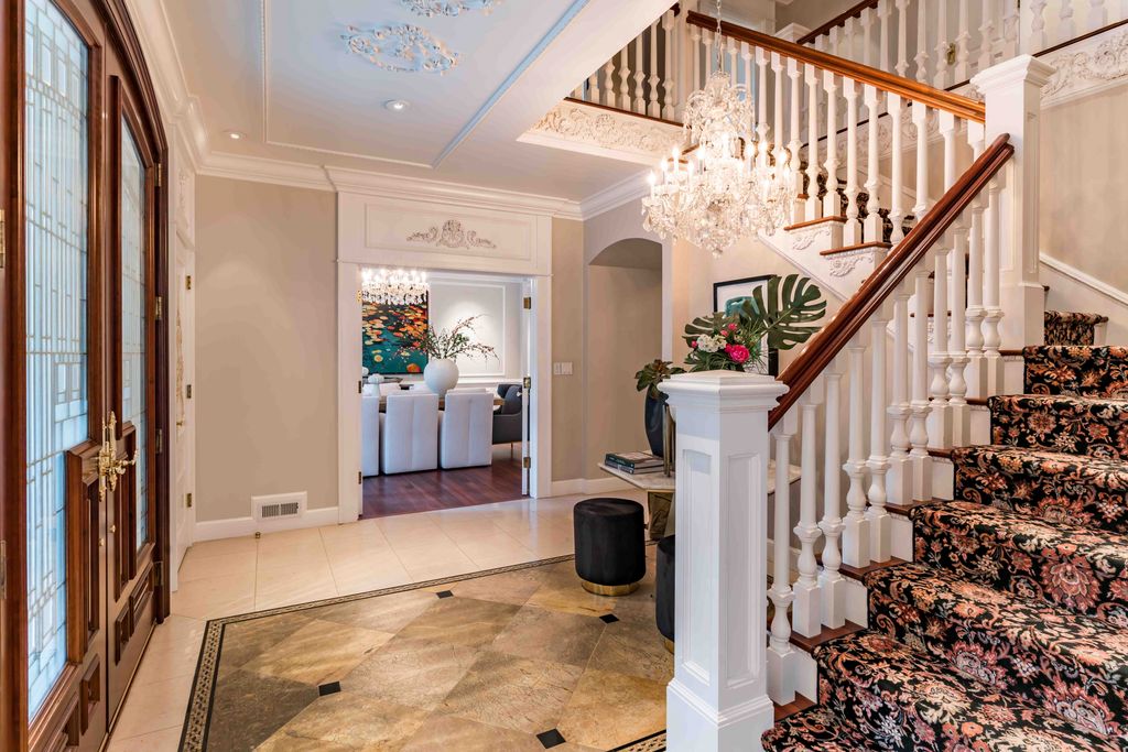 18 Cowell Lane Home in Atherton, California. Indulge in the perfect blend of privacy and luxury within the serene surroundings of this magnificent Atherton estate. Nestled on over an acre of meticulously maintained grounds, this exceptional home exudes style and elegance at every turn, boasting over 6,800 square feet of living space. Impeccable craftsmanship is showcased throughout, with exquisite details including stone, marble, and mahogany finishes. 