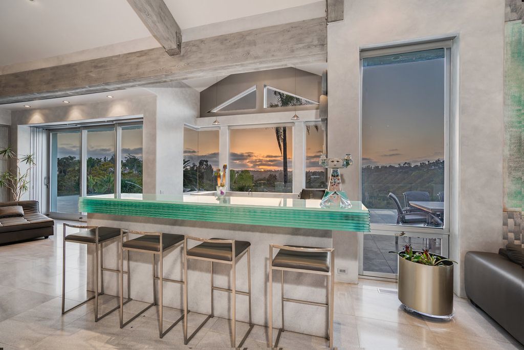Located at 6002 Via Posada Del Norte in Rancho Santa Fe, CA, this stunning contemporary home is a dream come true. Boasting 12 bedrooms, 10 bathrooms, and a living space of 12,745 square feet, this home is truly one-of-a-kind. Built in 2006, it sits on one of the most coveted lots in the prestigious guard-gated community of Fairbanks Ranch.