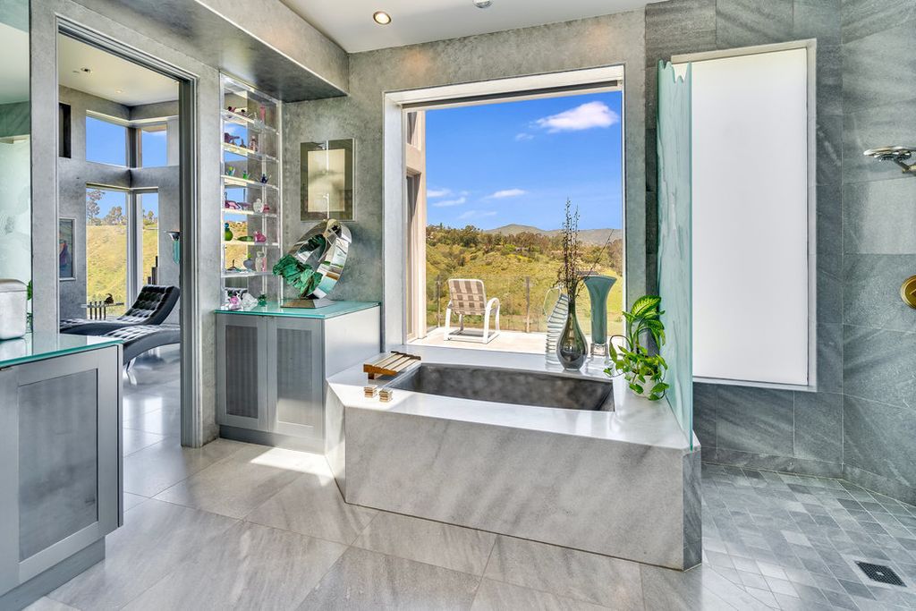 Located at 6002 Via Posada Del Norte in Rancho Santa Fe, CA, this stunning contemporary home is a dream come true. Boasting 12 bedrooms, 10 bathrooms, and a living space of 12,745 square feet, this home is truly one-of-a-kind. Built in 2006, it sits on one of the most coveted lots in the prestigious guard-gated community of Fairbanks Ranch.