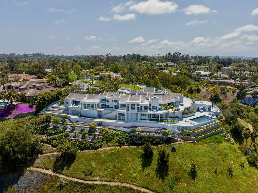 Located at 6002 Via Posada Del Norte in Rancho Santa Fe, CA, this stunning contemporary home is a dream come true. Boasting 12 bedrooms, 10 bathrooms, and a living space of 12,745 square feet, this home is truly one-of-a-kind. Built in 2006, it sits on one of the most coveted lots in the prestigious guard-gated community of Fairbanks Ranch.