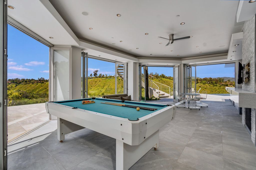 Located at 6002 Via Posada Del Norte in Rancho Santa Fe, CA, this stunning contemporary home is a dream come true. Boasting 12 bedrooms, 10 bathrooms, and a living space of 12,745 square feet, this home is truly one-of-a-kind. Built in 2006, it sits on one of the most coveted lots in the prestigious guard-gated community of Fairbanks Ranch.