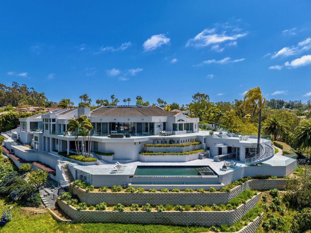 Located at 6002 Via Posada Del Norte in Rancho Santa Fe, CA, this stunning contemporary home is a dream come true. Boasting 12 bedrooms, 10 bathrooms, and a living space of 12,745 square feet, this home is truly one-of-a-kind. Built in 2006, it sits on one of the most coveted lots in the prestigious guard-gated community of Fairbanks Ranch.