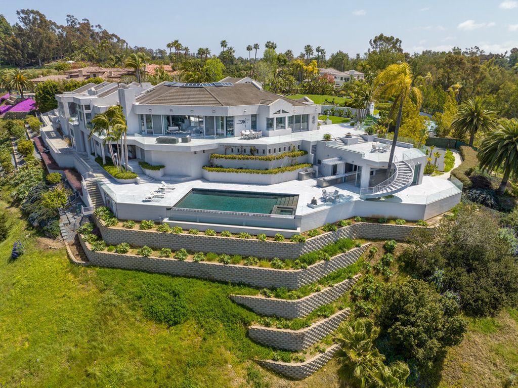 Located at 6002 Via Posada Del Norte in Rancho Santa Fe, CA, this stunning contemporary home is a dream come true. Boasting 12 bedrooms, 10 bathrooms, and a living space of 12,745 square feet, this home is truly one-of-a-kind. Built in 2006, it sits on one of the most coveted lots in the prestigious guard-gated community of Fairbanks Ranch.