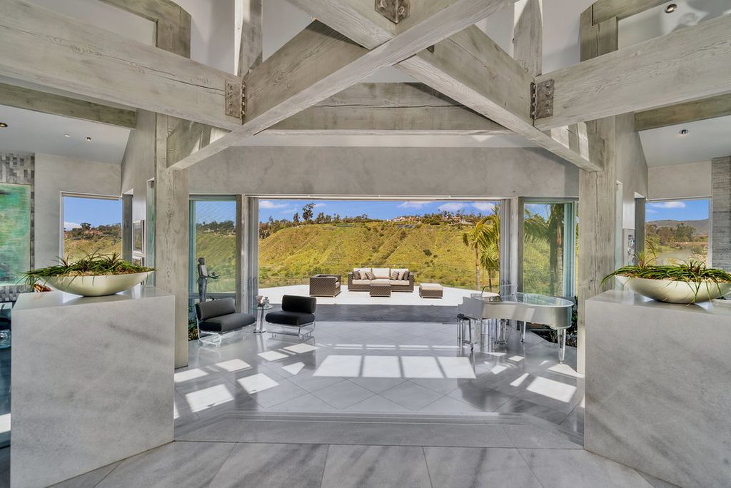 Located at 6002 Via Posada Del Norte in Rancho Santa Fe, CA, this stunning contemporary home is a dream come true. Boasting 12 bedrooms, 10 bathrooms, and a living space of 12,745 square feet, this home is truly one-of-a-kind. Built in 2006, it sits on one of the most coveted lots in the prestigious guard-gated community of Fairbanks Ranch.