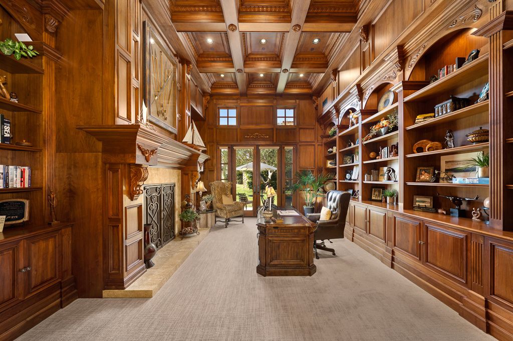 Indulge in the lavishness of a sprawling Mediterranean estate located on 4.71 acres in the sought-after Rancho Santa Fe. This private gated property boasts a grand Tuscan villa with a circular drive featuring a serene fountain and four separate stone and vine-covered structures surrounded by lush greenery.