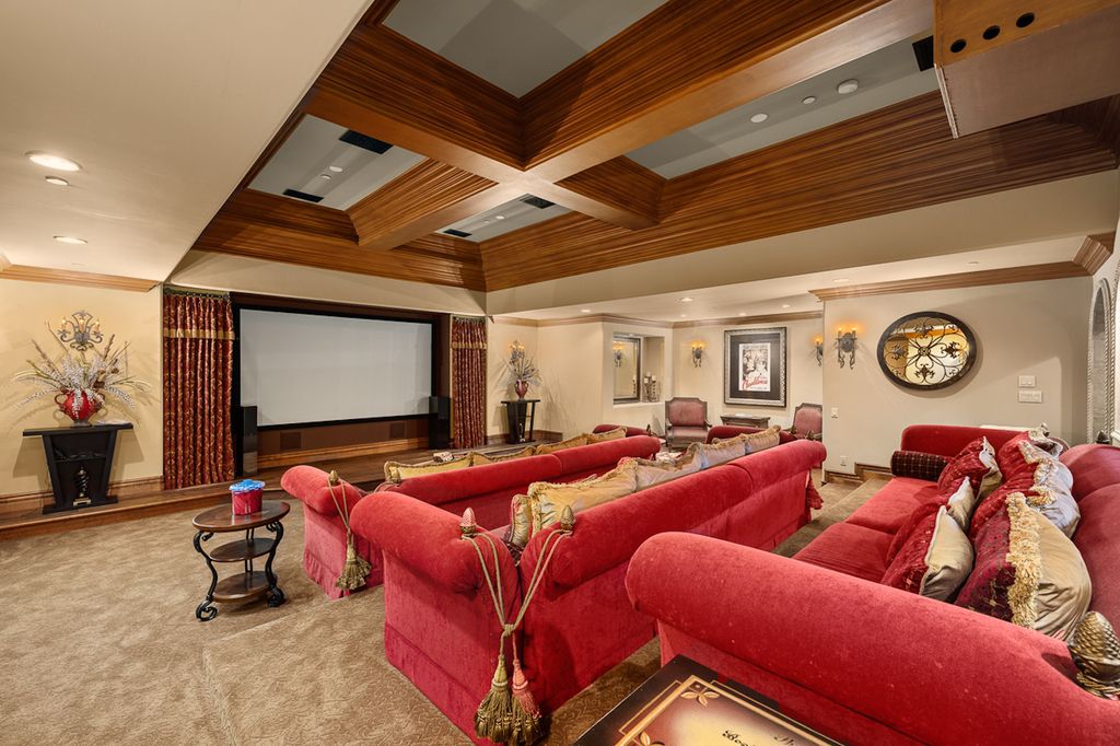 Indulge in the lavishness of a sprawling Mediterranean estate located on 4.71 acres in the sought-after Rancho Santa Fe. This private gated property boasts a grand Tuscan villa with a circular drive featuring a serene fountain and four separate stone and vine-covered structures surrounded by lush greenery.