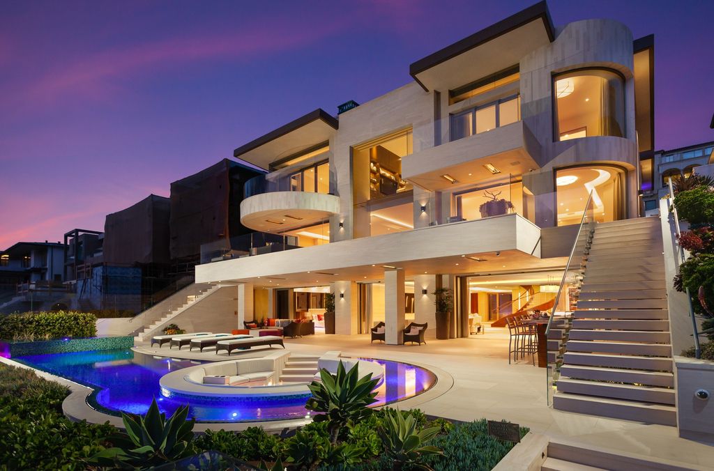 7 Strand Beach Drive in Dana Point, CA is an exquisite property that boasts breathtaking Pacific Ocean views, unparalleled contemporary architecture, and a prime location at The Strand at Headlands. Built in 2018 by Brown Brothers Construction, this modern custom showplace features approximately 9,630 square feet of living space, six ensuite bedrooms, and seven-and-a-half baths, including two primary suites and a junior suite on the top level.