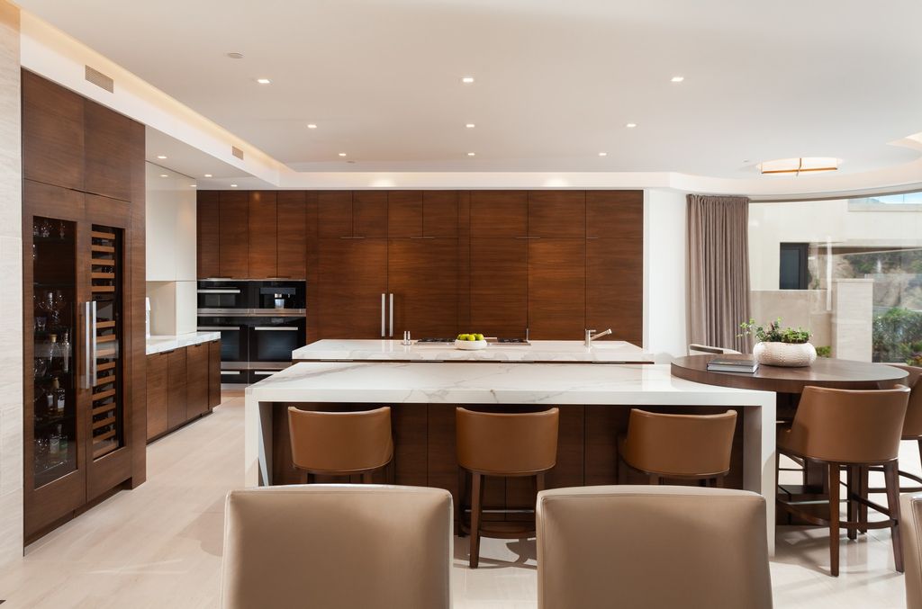 7 Strand Beach Drive in Dana Point, CA is an exquisite property that boasts breathtaking Pacific Ocean views, unparalleled contemporary architecture, and a prime location at The Strand at Headlands. Built in 2018 by Brown Brothers Construction, this modern custom showplace features approximately 9,630 square feet of living space, six ensuite bedrooms, and seven-and-a-half baths, including two primary suites and a junior suite on the top level.