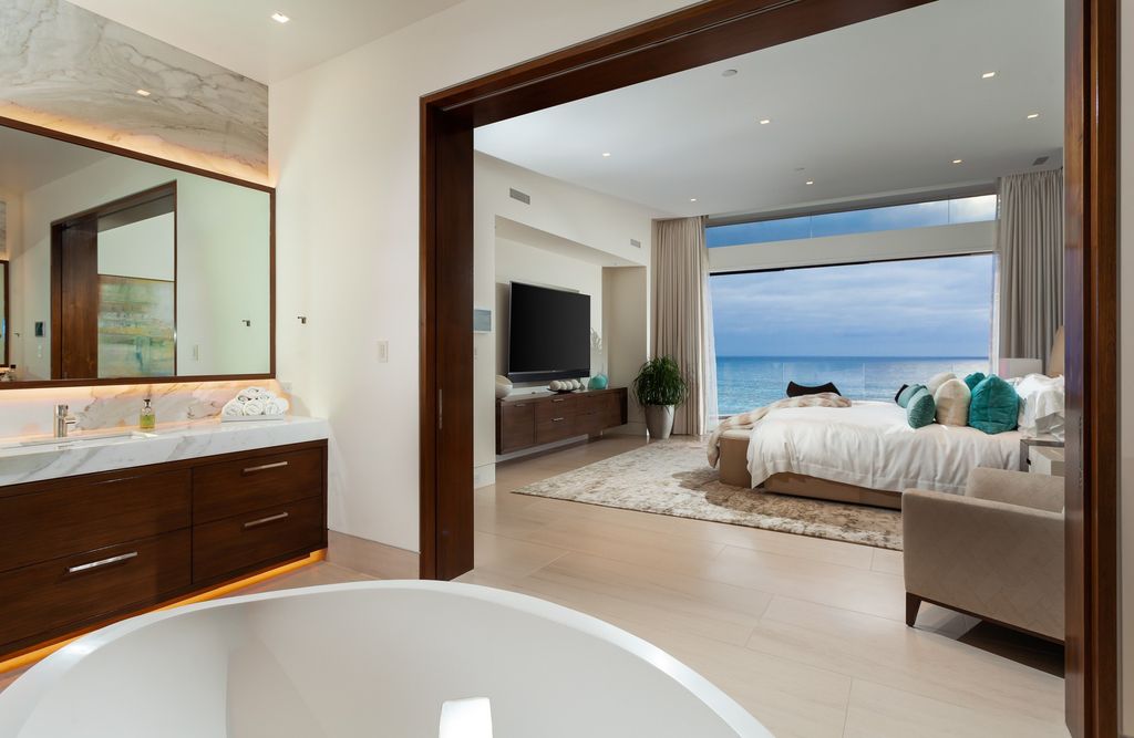 7 Strand Beach Drive in Dana Point, CA is an exquisite property that boasts breathtaking Pacific Ocean views, unparalleled contemporary architecture, and a prime location at The Strand at Headlands. Built in 2018 by Brown Brothers Construction, this modern custom showplace features approximately 9,630 square feet of living space, six ensuite bedrooms, and seven-and-a-half baths, including two primary suites and a junior suite on the top level.