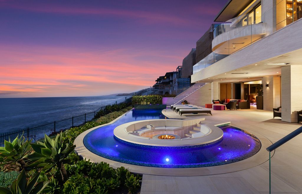 7 Strand Beach Drive in Dana Point, CA is an exquisite property that boasts breathtaking Pacific Ocean views, unparalleled contemporary architecture, and a prime location at The Strand at Headlands. Built in 2018 by Brown Brothers Construction, this modern custom showplace features approximately 9,630 square feet of living space, six ensuite bedrooms, and seven-and-a-half baths, including two primary suites and a junior suite on the top level.