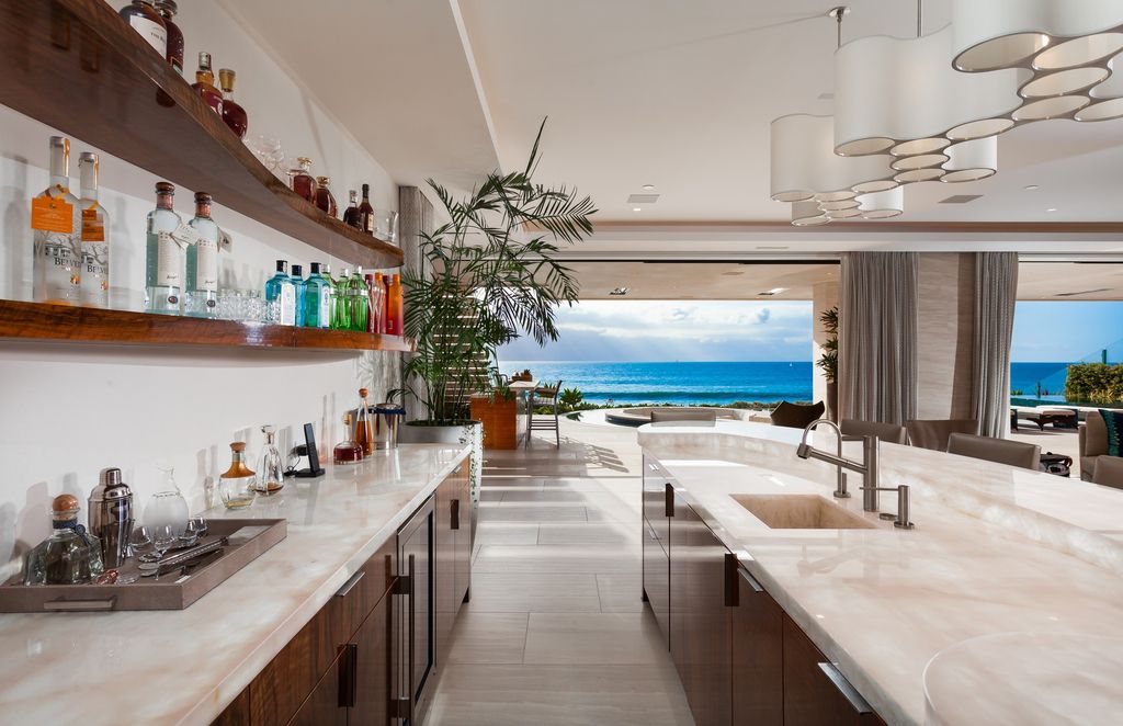 7 Strand Beach Drive in Dana Point, CA is an exquisite property that boasts breathtaking Pacific Ocean views, unparalleled contemporary architecture, and a prime location at The Strand at Headlands. Built in 2018 by Brown Brothers Construction, this modern custom showplace features approximately 9,630 square feet of living space, six ensuite bedrooms, and seven-and-a-half baths, including two primary suites and a junior suite on the top level.
