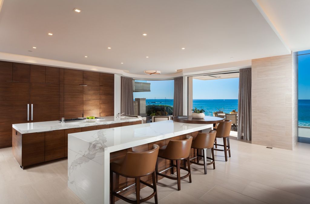 7 Strand Beach Drive in Dana Point, CA is an exquisite property that boasts breathtaking Pacific Ocean views, unparalleled contemporary architecture, and a prime location at The Strand at Headlands. Built in 2018 by Brown Brothers Construction, this modern custom showplace features approximately 9,630 square feet of living space, six ensuite bedrooms, and seven-and-a-half baths, including two primary suites and a junior suite on the top level.