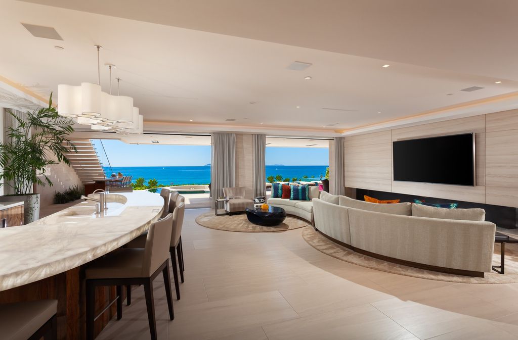 7 Strand Beach Drive in Dana Point, CA is an exquisite property that boasts breathtaking Pacific Ocean views, unparalleled contemporary architecture, and a prime location at The Strand at Headlands. Built in 2018 by Brown Brothers Construction, this modern custom showplace features approximately 9,630 square feet of living space, six ensuite bedrooms, and seven-and-a-half baths, including two primary suites and a junior suite on the top level.