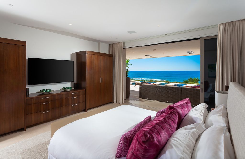 7 Strand Beach Drive in Dana Point, CA is an exquisite property that boasts breathtaking Pacific Ocean views, unparalleled contemporary architecture, and a prime location at The Strand at Headlands. Built in 2018 by Brown Brothers Construction, this modern custom showplace features approximately 9,630 square feet of living space, six ensuite bedrooms, and seven-and-a-half baths, including two primary suites and a junior suite on the top level.