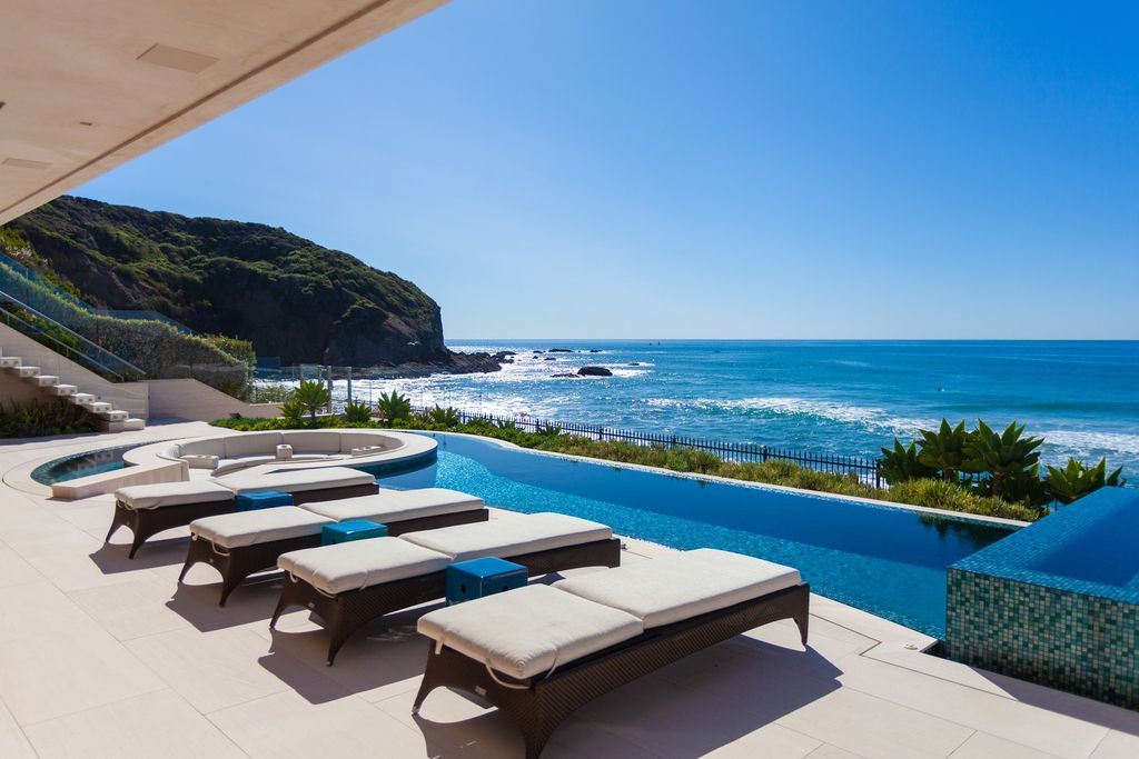 7 Strand Beach Drive in Dana Point, CA is an exquisite property that boasts breathtaking Pacific Ocean views, unparalleled contemporary architecture, and a prime location at The Strand at Headlands. Built in 2018 by Brown Brothers Construction, this modern custom showplace features approximately 9,630 square feet of living space, six ensuite bedrooms, and seven-and-a-half baths, including two primary suites and a junior suite on the top level.