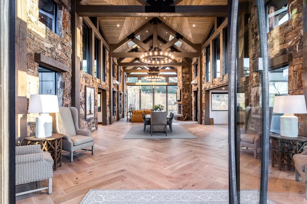 7600 E Deer Knoll Drive Home in Heber City, Utah. This custom-built home in Lashbrooke community offers a functional floor plan and ideal space for entertaining. With a main-level primary bedroom, gourmet kitchen, and great room opening to the keeping room, this home is perfect for hosting guests.