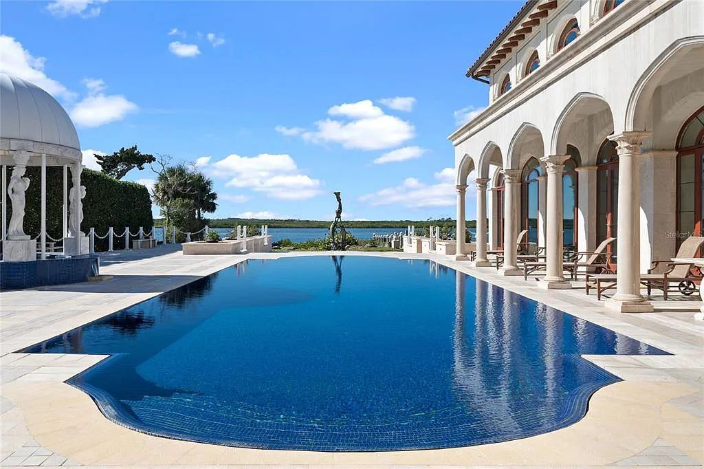 Discover the ultimate in luxury living at 4852 S Peninsula Drive in Ponce Inlet, Florida. This privately gated 3-acre waterfront estate boasts 6 bedrooms, 9 bathrooms, 12,126 sq ft of living space, and a 2.80-acre lot size built in 2004.