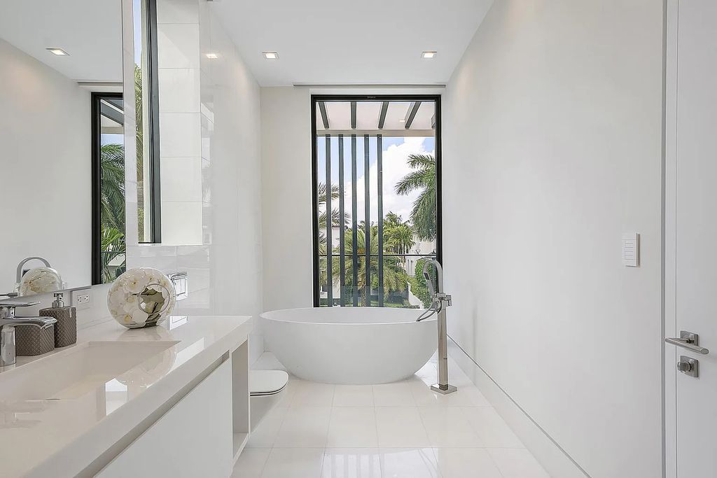 Discover this awe-inspiring waterfront estate at 224 W Key Palm Road, Boca Raton, Florida. Built in 2023 by Sarkela Corp and Ada Architecture Design Atelier, this luxurious property boasts 6 opulent bedrooms, 7 full and 2 half baths, and over 9,500 sq ft of palatial living space.