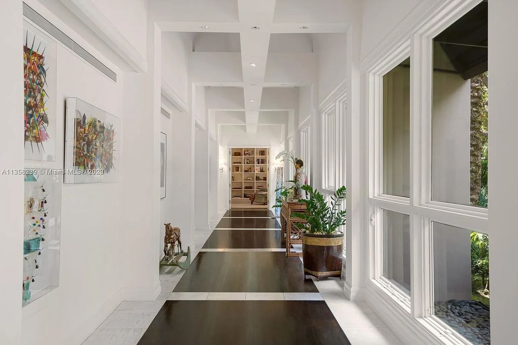 Experience unparalleled luxury in this lakefront estate located at 10201 Sabal Palm Avenue, Coral Gables, Florida. With 5 bedrooms, 7 bathrooms, and 2 half-bathrooms, this sprawling 9,266 sq ft home boasts an infinity saltwater pool, custom-designed kitchen, and floor-to-ceiling windows.