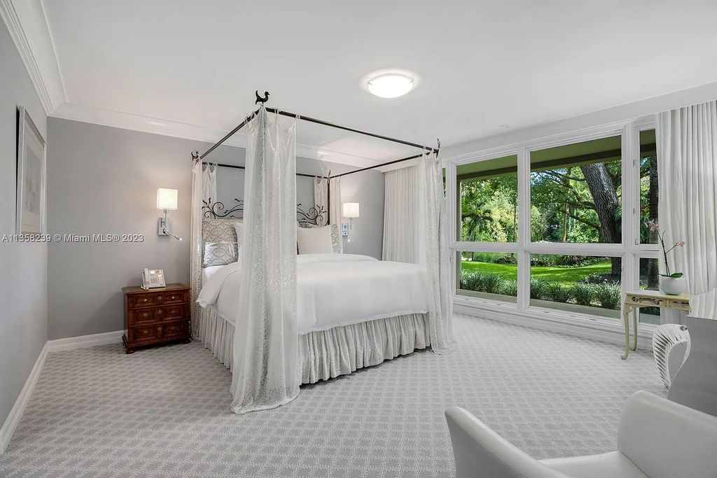 Experience unparalleled luxury in this lakefront estate located at 10201 Sabal Palm Avenue, Coral Gables, Florida. With 5 bedrooms, 7 bathrooms, and 2 half-bathrooms, this sprawling 9,266 sq ft home boasts an infinity saltwater pool, custom-designed kitchen, and floor-to-ceiling windows.