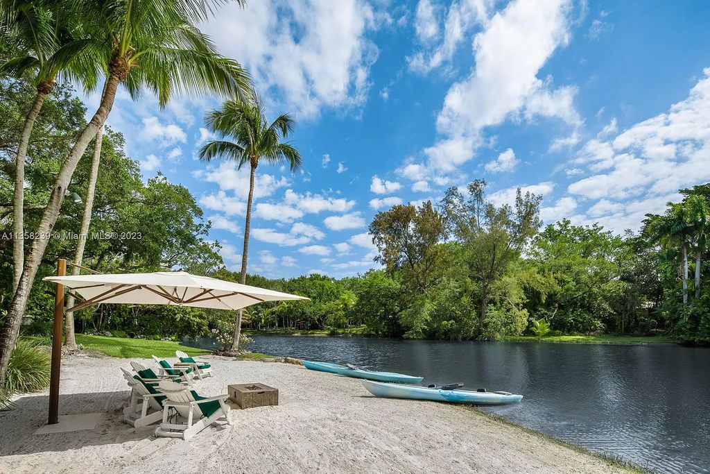 Experience unparalleled luxury in this lakefront estate located at 10201 Sabal Palm Avenue, Coral Gables, Florida. With 5 bedrooms, 7 bathrooms, and 2 half-bathrooms, this sprawling 9,266 sq ft home boasts an infinity saltwater pool, custom-designed kitchen, and floor-to-ceiling windows.