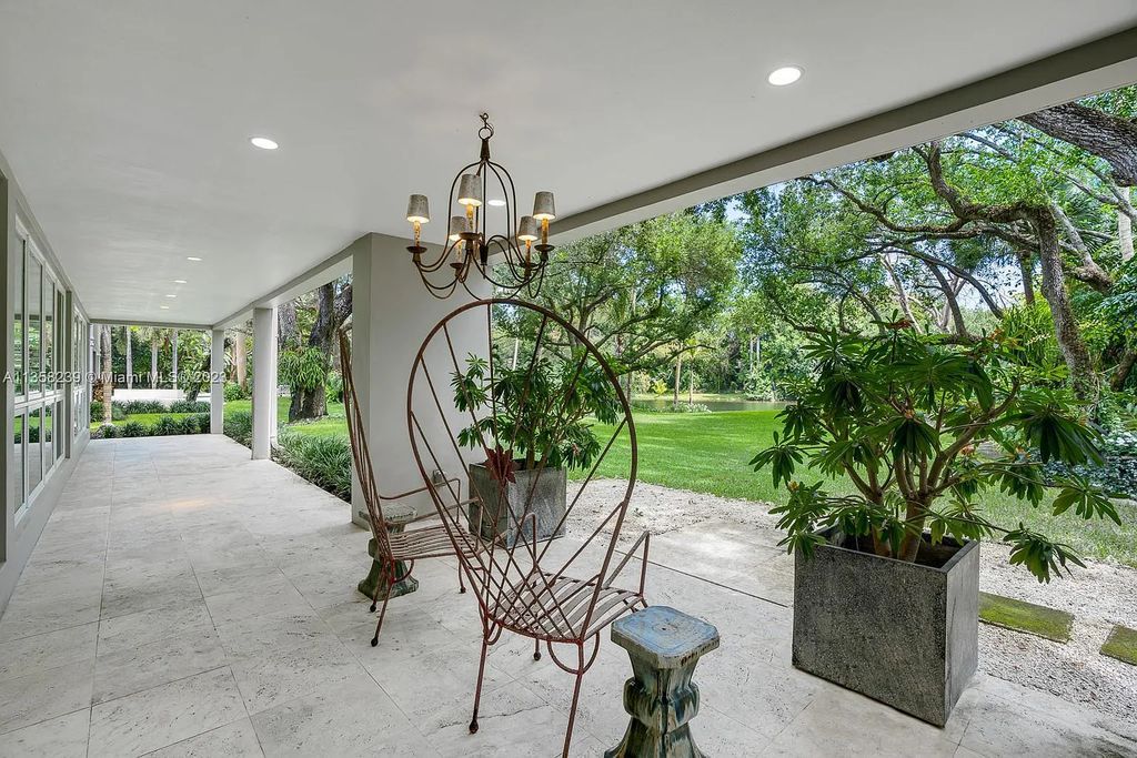 Experience unparalleled luxury in this lakefront estate located at 10201 Sabal Palm Avenue, Coral Gables, Florida. With 5 bedrooms, 7 bathrooms, and 2 half-bathrooms, this sprawling 9,266 sq ft home boasts an infinity saltwater pool, custom-designed kitchen, and floor-to-ceiling windows.