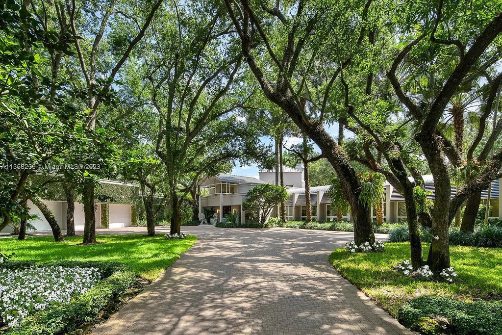 Experience unparalleled luxury in this lakefront estate located at 10201 Sabal Palm Avenue, Coral Gables, Florida. With 5 bedrooms, 7 bathrooms, and 2 half-bathrooms, this sprawling 9,266 sq ft home boasts an infinity saltwater pool, custom-designed kitchen, and floor-to-ceiling windows.