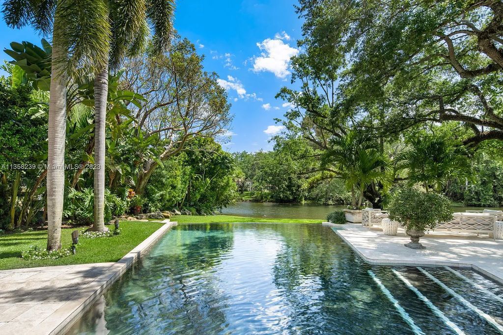 Experience unparalleled luxury in this lakefront estate located at 10201 Sabal Palm Avenue, Coral Gables, Florida. With 5 bedrooms, 7 bathrooms, and 2 half-bathrooms, this sprawling 9,266 sq ft home boasts an infinity saltwater pool, custom-designed kitchen, and floor-to-ceiling windows.