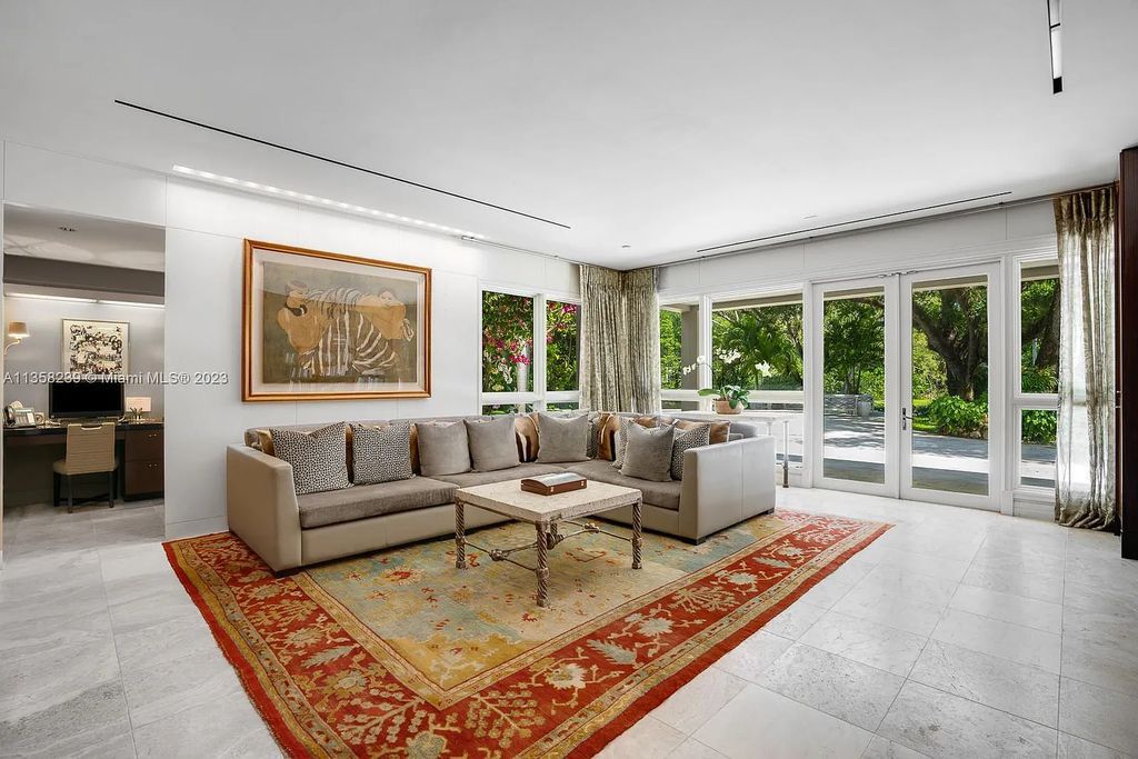 Experience unparalleled luxury in this lakefront estate located at 10201 Sabal Palm Avenue, Coral Gables, Florida. With 5 bedrooms, 7 bathrooms, and 2 half-bathrooms, this sprawling 9,266 sq ft home boasts an infinity saltwater pool, custom-designed kitchen, and floor-to-ceiling windows.