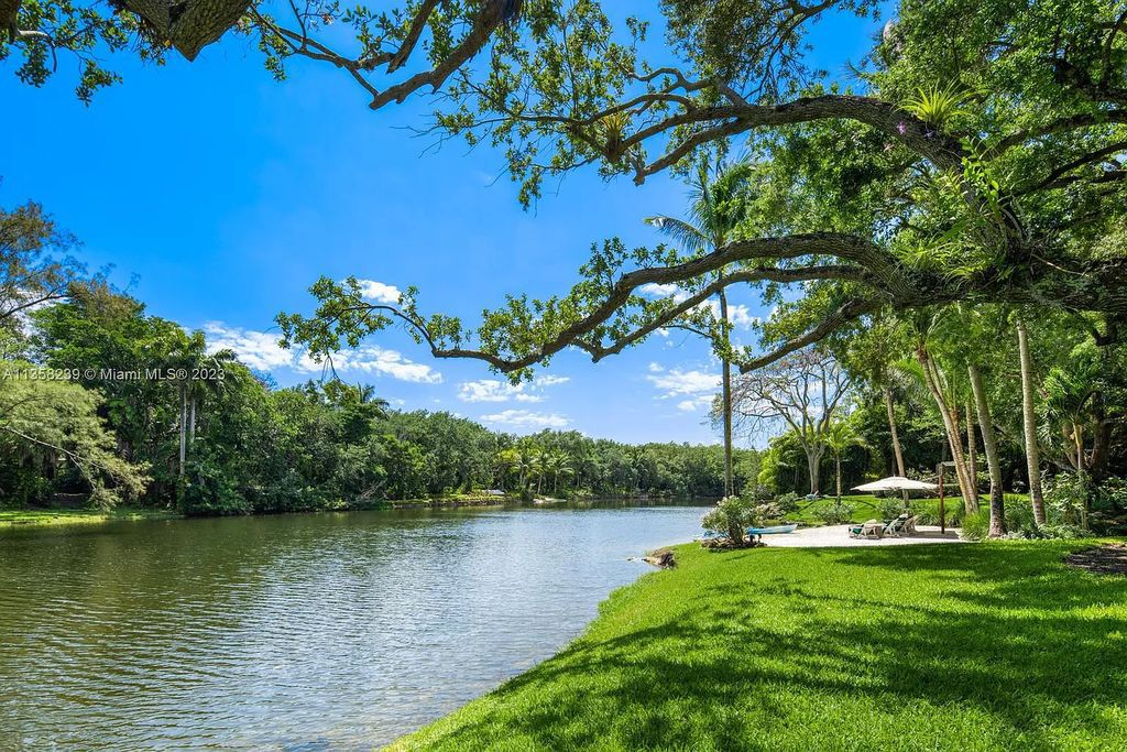 Experience unparalleled luxury in this lakefront estate located at 10201 Sabal Palm Avenue, Coral Gables, Florida. With 5 bedrooms, 7 bathrooms, and 2 half-bathrooms, this sprawling 9,266 sq ft home boasts an infinity saltwater pool, custom-designed kitchen, and floor-to-ceiling windows.