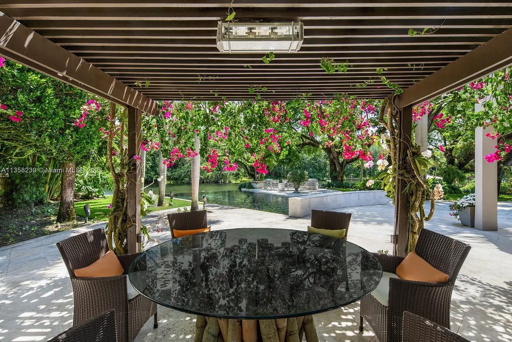 Experience unparalleled luxury in this lakefront estate located at 10201 Sabal Palm Avenue, Coral Gables, Florida. With 5 bedrooms, 7 bathrooms, and 2 half-bathrooms, this sprawling 9,266 sq ft home boasts an infinity saltwater pool, custom-designed kitchen, and floor-to-ceiling windows.