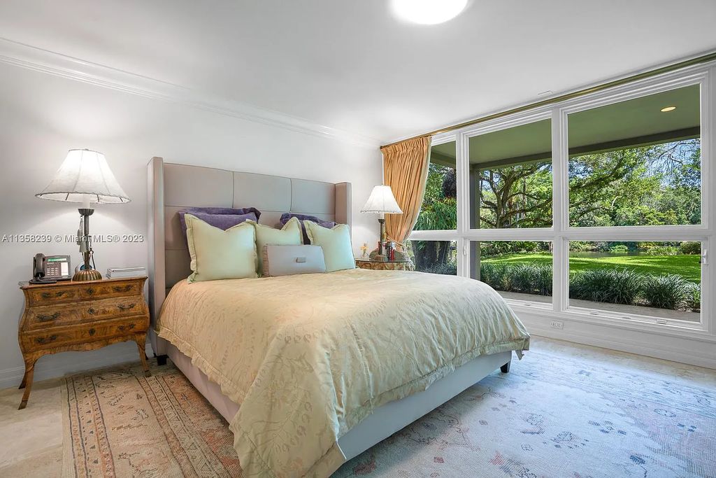 Experience unparalleled luxury in this lakefront estate located at 10201 Sabal Palm Avenue, Coral Gables, Florida. With 5 bedrooms, 7 bathrooms, and 2 half-bathrooms, this sprawling 9,266 sq ft home boasts an infinity saltwater pool, custom-designed kitchen, and floor-to-ceiling windows.