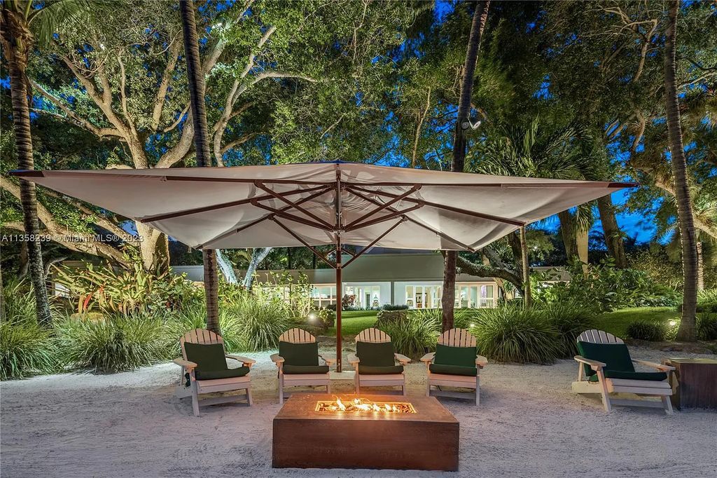 Experience unparalleled luxury in this lakefront estate located at 10201 Sabal Palm Avenue, Coral Gables, Florida. With 5 bedrooms, 7 bathrooms, and 2 half-bathrooms, this sprawling 9,266 sq ft home boasts an infinity saltwater pool, custom-designed kitchen, and floor-to-ceiling windows.