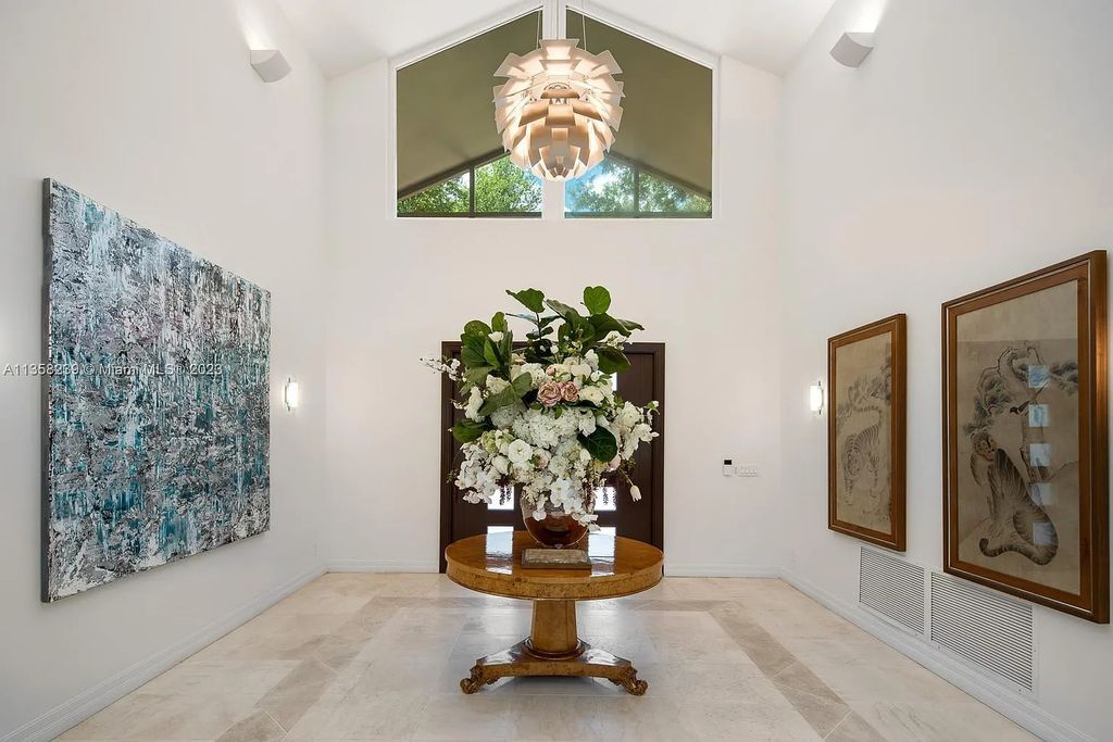 Experience unparalleled luxury in this lakefront estate located at 10201 Sabal Palm Avenue, Coral Gables, Florida. With 5 bedrooms, 7 bathrooms, and 2 half-bathrooms, this sprawling 9,266 sq ft home boasts an infinity saltwater pool, custom-designed kitchen, and floor-to-ceiling windows.