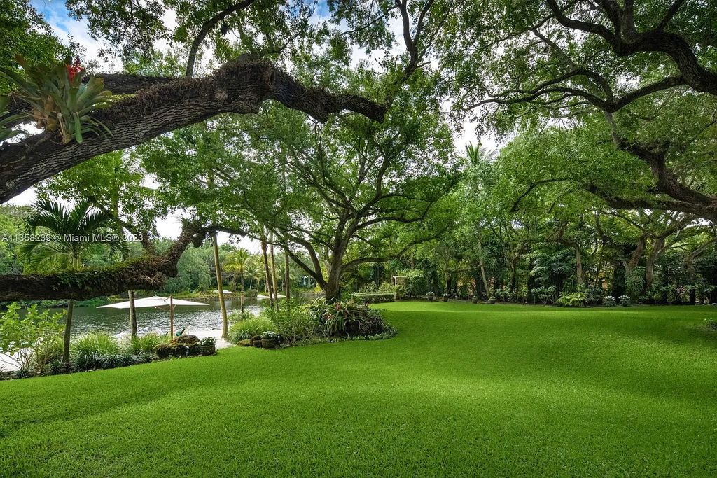 Experience unparalleled luxury in this lakefront estate located at 10201 Sabal Palm Avenue, Coral Gables, Florida. With 5 bedrooms, 7 bathrooms, and 2 half-bathrooms, this sprawling 9,266 sq ft home boasts an infinity saltwater pool, custom-designed kitchen, and floor-to-ceiling windows.