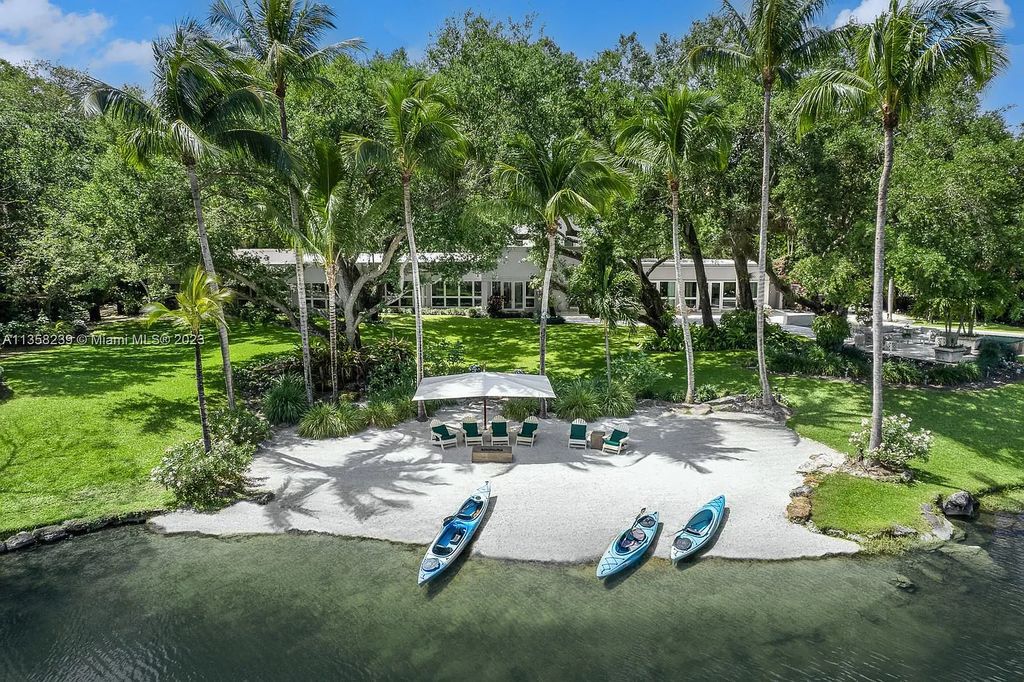 Experience unparalleled luxury in this lakefront estate located at 10201 Sabal Palm Avenue, Coral Gables, Florida. With 5 bedrooms, 7 bathrooms, and 2 half-bathrooms, this sprawling 9,266 sq ft home boasts an infinity saltwater pool, custom-designed kitchen, and floor-to-ceiling windows.