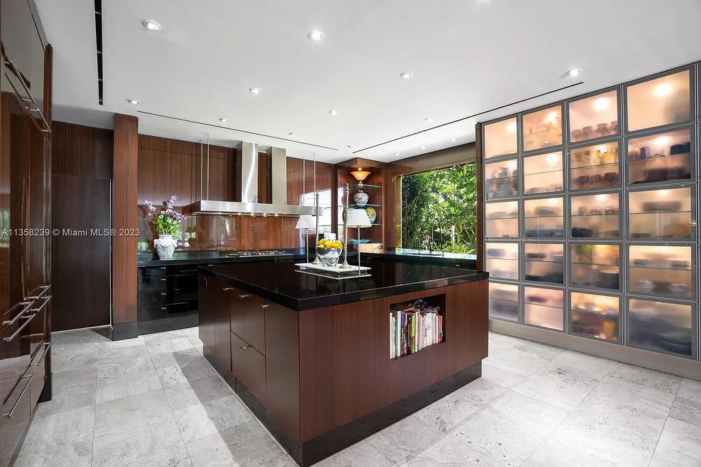 Experience unparalleled luxury in this lakefront estate located at 10201 Sabal Palm Avenue, Coral Gables, Florida. With 5 bedrooms, 7 bathrooms, and 2 half-bathrooms, this sprawling 9,266 sq ft home boasts an infinity saltwater pool, custom-designed kitchen, and floor-to-ceiling windows.