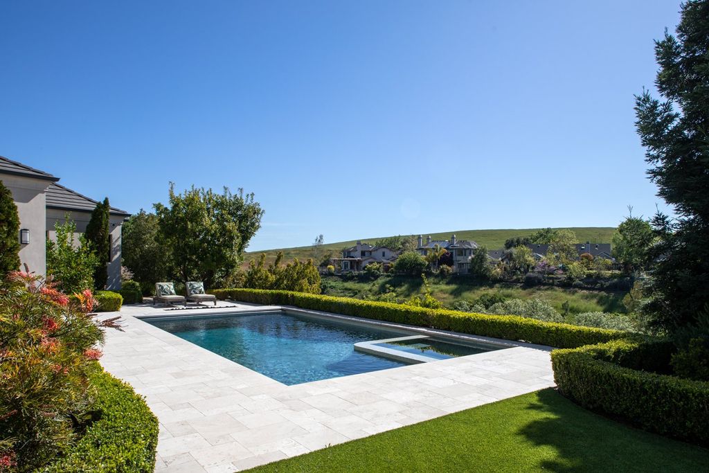 10450 Serra Street Home in Cupertino, California. A Private Silicon Valley Haven - This exceptional estate is tucked away in a tranquil cul-de-sac, providing a serene retreat within close proximity to the vibrant Silicon Valley. Surrounded by the natural beauty of Rancho San Antonio Preserve, this stunning home offers hiking and biking trails and breathtaking views. 