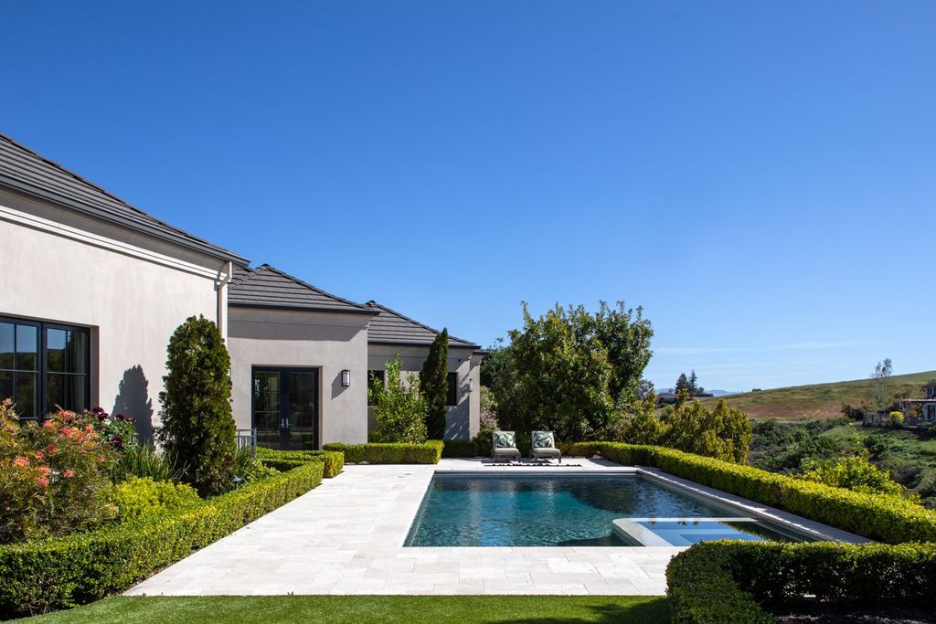 10450 Serra Street Home in Cupertino, California. A Private Silicon Valley Haven - This exceptional estate is tucked away in a tranquil cul-de-sac, providing a serene retreat within close proximity to the vibrant Silicon Valley. Surrounded by the natural beauty of Rancho San Antonio Preserve, this stunning home offers hiking and biking trails and breathtaking views. 