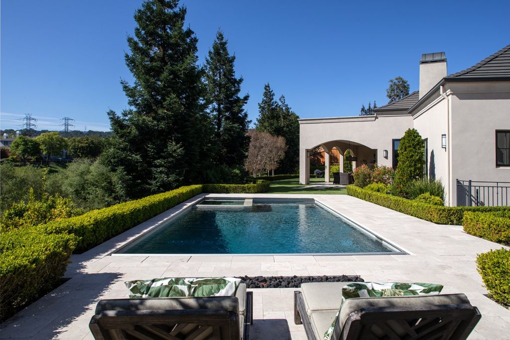 10450 Serra Street Home in Cupertino, California. A Private Silicon Valley Haven - This exceptional estate is tucked away in a tranquil cul-de-sac, providing a serene retreat within close proximity to the vibrant Silicon Valley. Surrounded by the natural beauty of Rancho San Antonio Preserve, this stunning home offers hiking and biking trails and breathtaking views. 