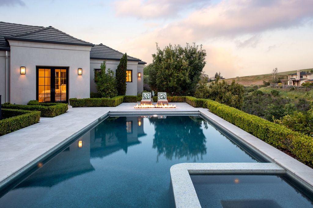 10450 Serra Street Home in Cupertino, California. A Private Silicon Valley Haven - This exceptional estate is tucked away in a tranquil cul-de-sac, providing a serene retreat within close proximity to the vibrant Silicon Valley. Surrounded by the natural beauty of Rancho San Antonio Preserve, this stunning home offers hiking and biking trails and breathtaking views. 